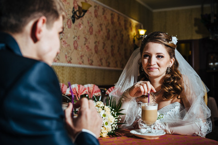 Love you honey.  Newly wed couple drinking cappuccino in cafe.の写真素材