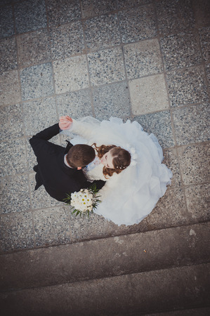 Elegant bride and groom posing together outdoors on a wedding day.の写真素材