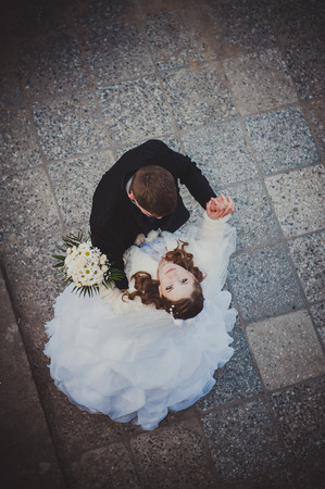 Elegant bride and groom posing together outdoors on a wedding day.の写真素材