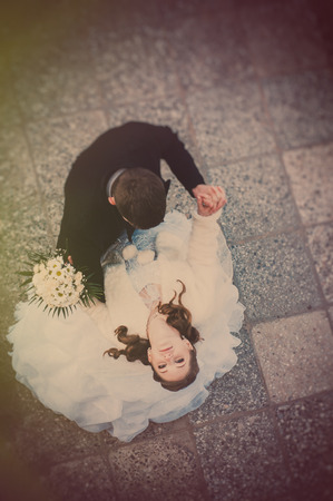 Elegant bride and groom posing together outdoors on a wedding day.の写真素材