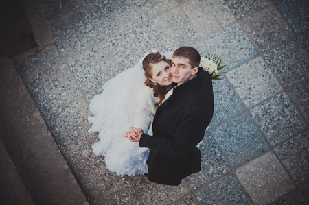 Elegant bride and groom posing together outdoors on a wedding day.の写真素材