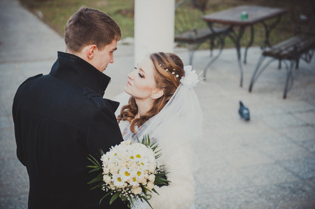 Elegant bride and groom posing together outdoors on a wedding day.の写真素材
