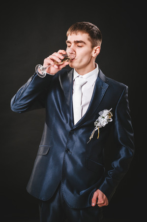 Hands of wedding groom getting ready in suit. black studio background.の写真素材