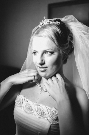Beautiful caucasian bride getting ready for the wedding ceremony.の写真素材