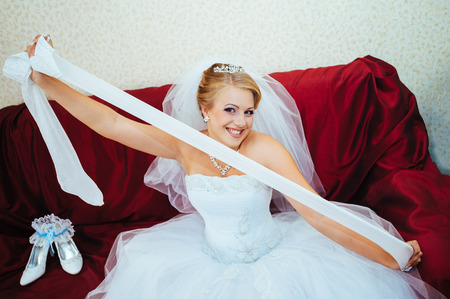 Beautiful caucasian bride getting ready for the wedding ceremony.の写真素材