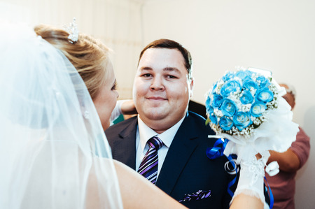 Handsome groom first time meets his bride at her house on a wedding day.の写真素材