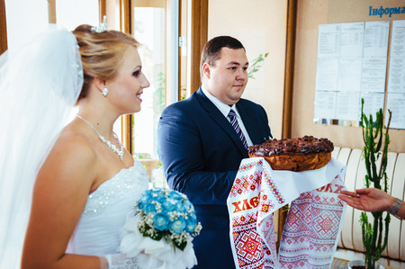 Wedding ceremony. Registry office. A newly-married couple signs the marriage document.Young couple signing wedding documents.の写真素材