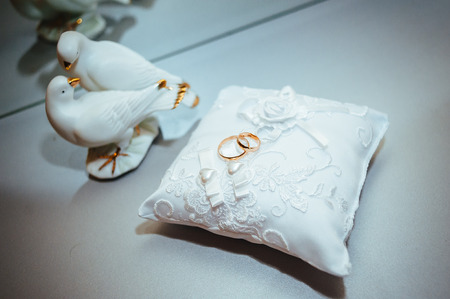 gold wedding rings on the pincushion. traditional jewelry symbolの写真素材