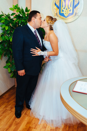 Wedding ceremony. Registry office. A newly-married couple signs the marriage document.Young couple signing wedding documents.の写真素材
