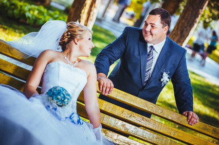 happy bride and groom swinging on a swingの写真素材