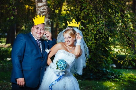 Bride and groom at wedding Day walking Outdoors on spring nature. Bridal couple, Happy Newlywed woman and man embracing in green park. Loving wedding couple outdoor. Bride and groom.の写真素材