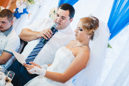 Charming bride and groom on their wedding celebration in a luxurious restaurantの写真素材