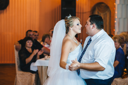 beautiful caucasian couple just married and dancing their first danceの写真素材