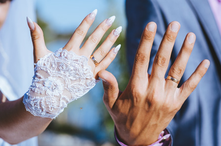 Groom and brides hands with rings, closeup view.の写真素材