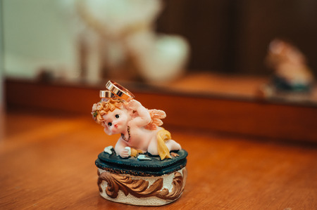 Wedding rings and Cupid statuette, wedding accessories.の写真素材
