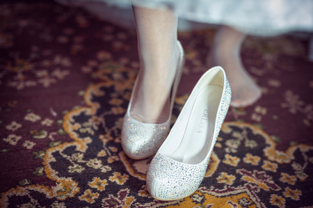 Bride is putting on her wedding shoes.の写真素材