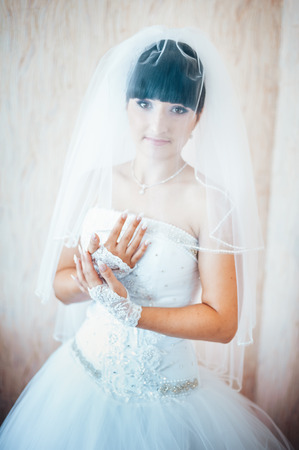 beautiful bride in white wedding dress with hairstyle and bright makeup. の写真素材
