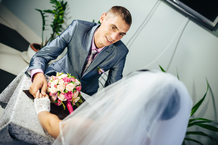 Charming bride and groom on their wedding celebration in a luxurious restaurant.の写真素材