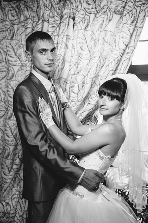 Charming bride and groom on their wedding celebration in a luxurious restaurant.の写真素材