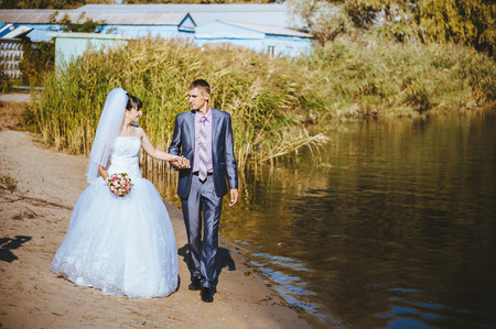 Bride and Groom at wedding Day walking Outdoors on spring nature. の写真素材