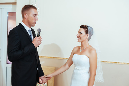 beautiful caucasian couple just married and dancing their first dance.の写真素材