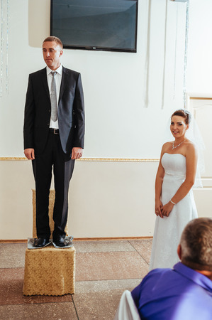 beautiful caucasian couple just married and dancing their first dance.の写真素材