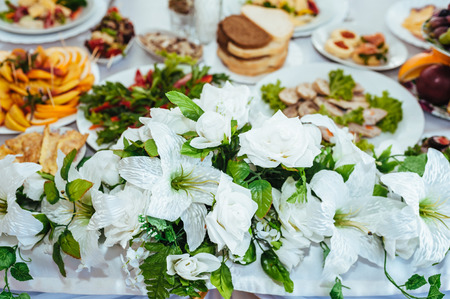 catering table set service with silverware and glass stemware at restaurant before partyの写真素材