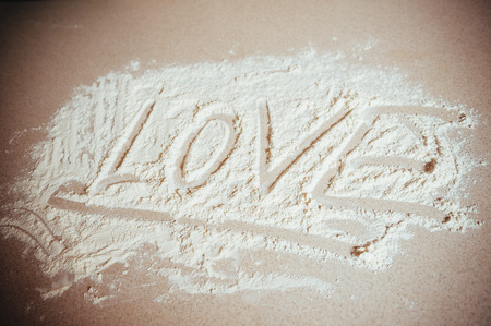 Inscription made by hand by sprinkled flour on a oven-trayの写真素材