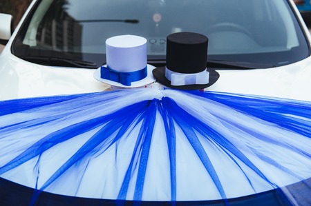 A black wedding car decorated with roses. Luxury wedding car decorated with flowers and ribbons.の写真素材