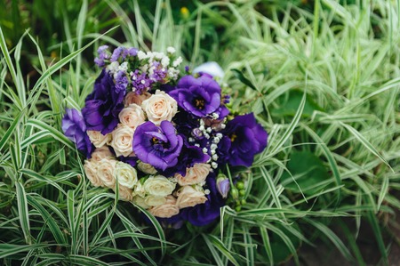 picture of a wedding bouquet , Wedding bouquet of pink and white roses lying on grass.の写真素材