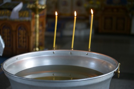 Holy water font for the baptism of children. The rite of initiation into the faith in the Christian...