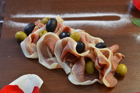 Salad of cold cuts with olive, salami, parma ham and cheeses.の写真素材