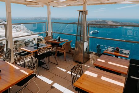 Dinning tables in a restaurant on Santorini island, Greeceの写真素材