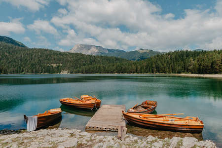 Boats on Black Lake - Crno jezero , northern Montenegro. It is a glacial lakeon the Mount Durmitor, on an altitude of 1,416 m. Black lake in Durmitor national park in Montenegro, Europe. Beauty world.の写真素材