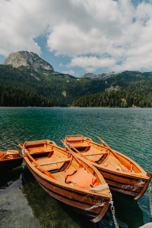 Boats on Black Lake - Crno jezero , northern Montenegro. It is a glacial lakeon the Mount Durmitor, on an altitude of 1,416 m. Black lake in Durmitor national park in Montenegro, Europe. Beauty world.の写真素材