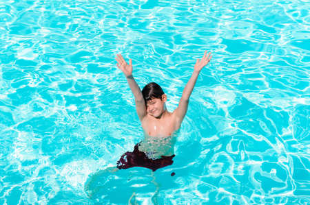 Activities on the pool, children swimming and playing in water, happiness and summertime. Young Boy...