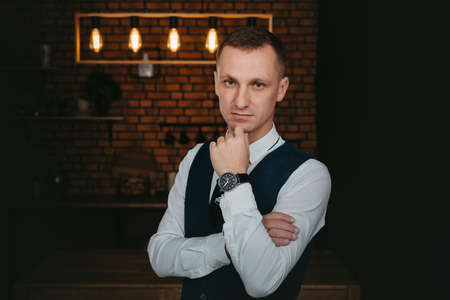 Morning of the groom. Groom morning preparation. Young and handsome groom getting dressed in a...