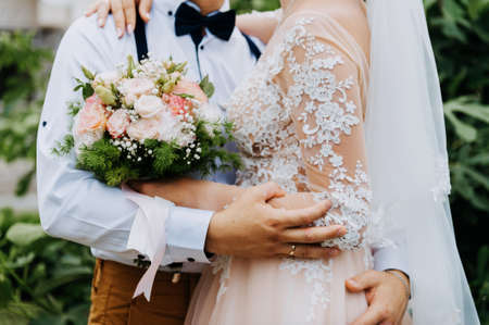 Sensual portrait of a young couple. Wedding photo outdoor. Wedding shot of bride and groom in park. Just married couple embraced.の写真素材