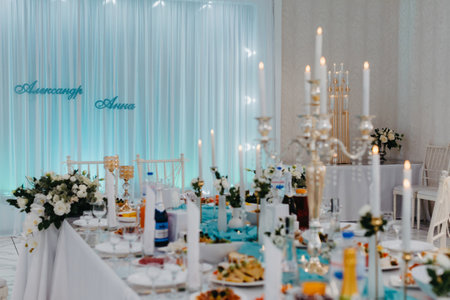 Wedding Banquet hall decorated with flowers. Table setting at a luxury wedding reception. Served for banquet tables in a luxurious interior.の写真素材