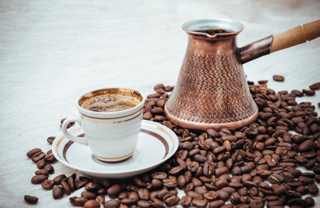 Coffee turk and cup of coffee on burlap background. coffee beans isolated on white background. roasted coffee beansの写真素材