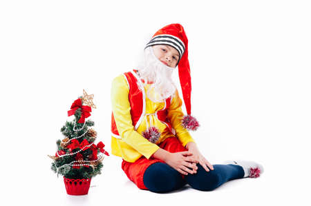 A baby dressed as a elf. isolated. Santas helper. boy in suit of dwarf or elf