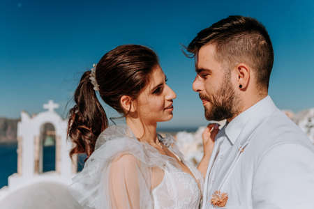 beautiful bride and groom in their summer wedding day on greek island Santoriniの写真素材