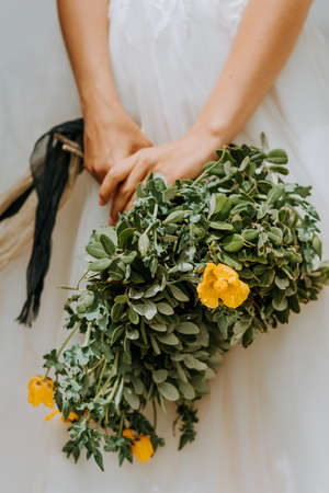 Young attractive bride holding the bouquet of flowers
