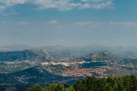 Panoramic view of idyllic mountain scenery in the Alps with fresh green meadows in bloom on a...