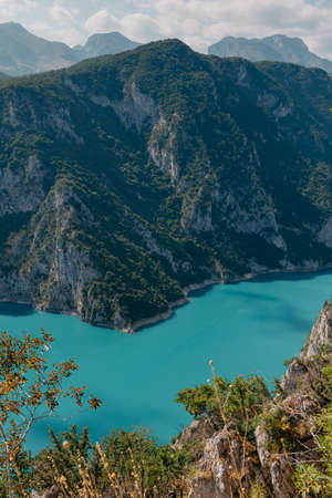 The concept of eco-tourism and active recreation. National Park. Mountain Emerald lake in the wooded...