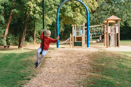 Funny cute happy baby playing on the playground. The emotion of happiness, fun, joy. Smile of a...