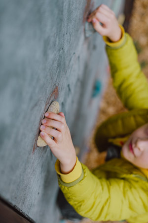 Boy At The Climbing Wall Without A Helmet, Danger At The Climbing Wall. Little Boy Climbing A Rock Wall Indoorの写真素材
