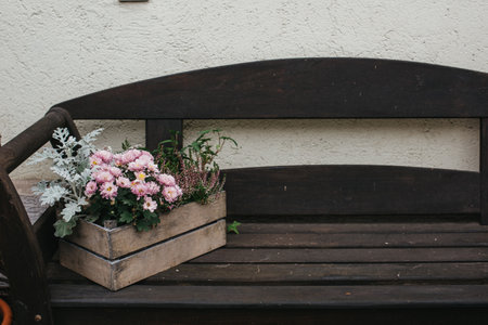 Vintage Outdoor Furniture, Mums And Nik-naks. Wooden Bench In Front Garden With Flower Boxes. Box With Flowers On The Bench. Wooden Bench In Front Garden With Flower Boxes. Box With Flowers On The Bench.の写真素材