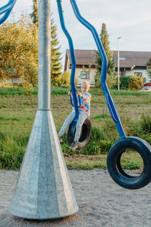 Funny cute happy baby playing on the playground. The emotion of happiness, fun, joy. Smile of a child. boy playing on the playgroundの写真素材