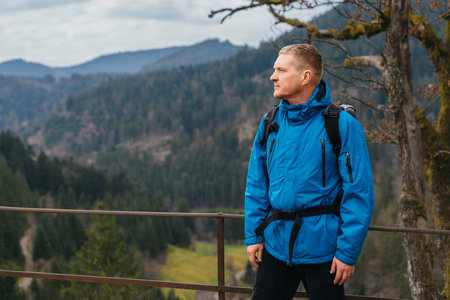 Traveler Man with backpack mountaineering Travel Lifestyle concept mountains on background Summer trip vacations outdoor. Concept of travel and healthy, active lifestyleの写真素材
